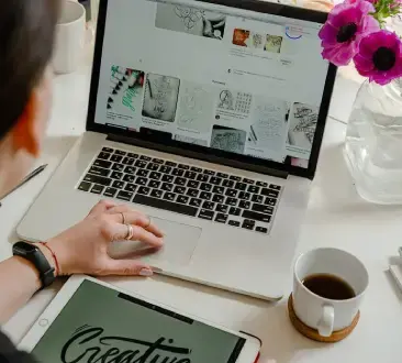 Person Using Macbook Pro on Table